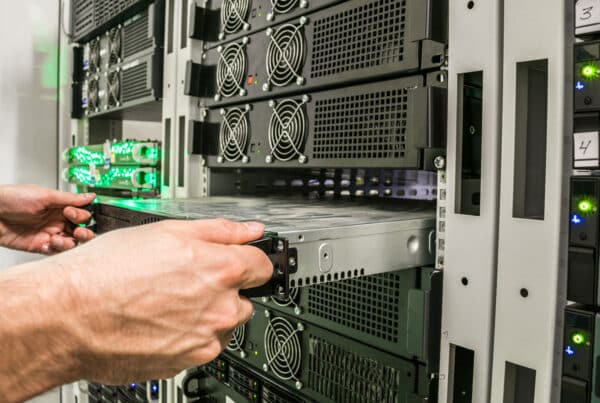 TAMS Solution technician breaking down a server stack during a data center decommissioning project.