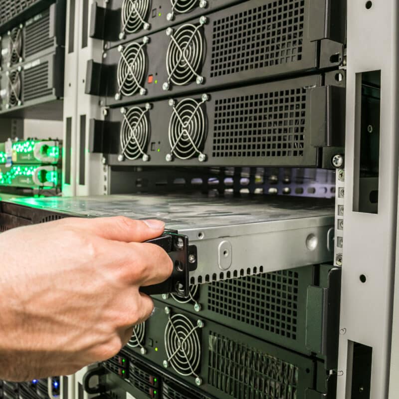 TAMS Solution technician breaking down a server stack during a data center decommissioning project.
