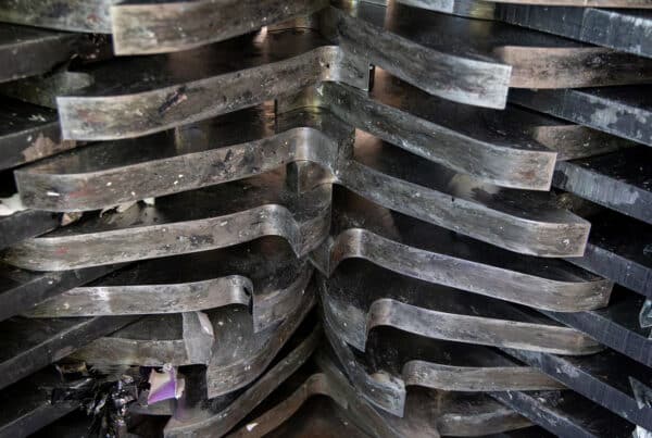 Close-up of a hard drive shredder crushing disks for compliant data destruction and e-waste processing