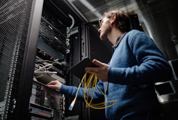 IT technician working on server racks during a financial institution IT refresh